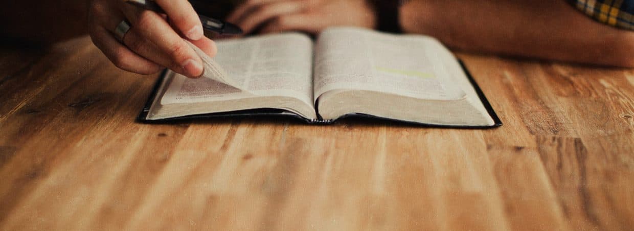 an open Bible on top of a desk