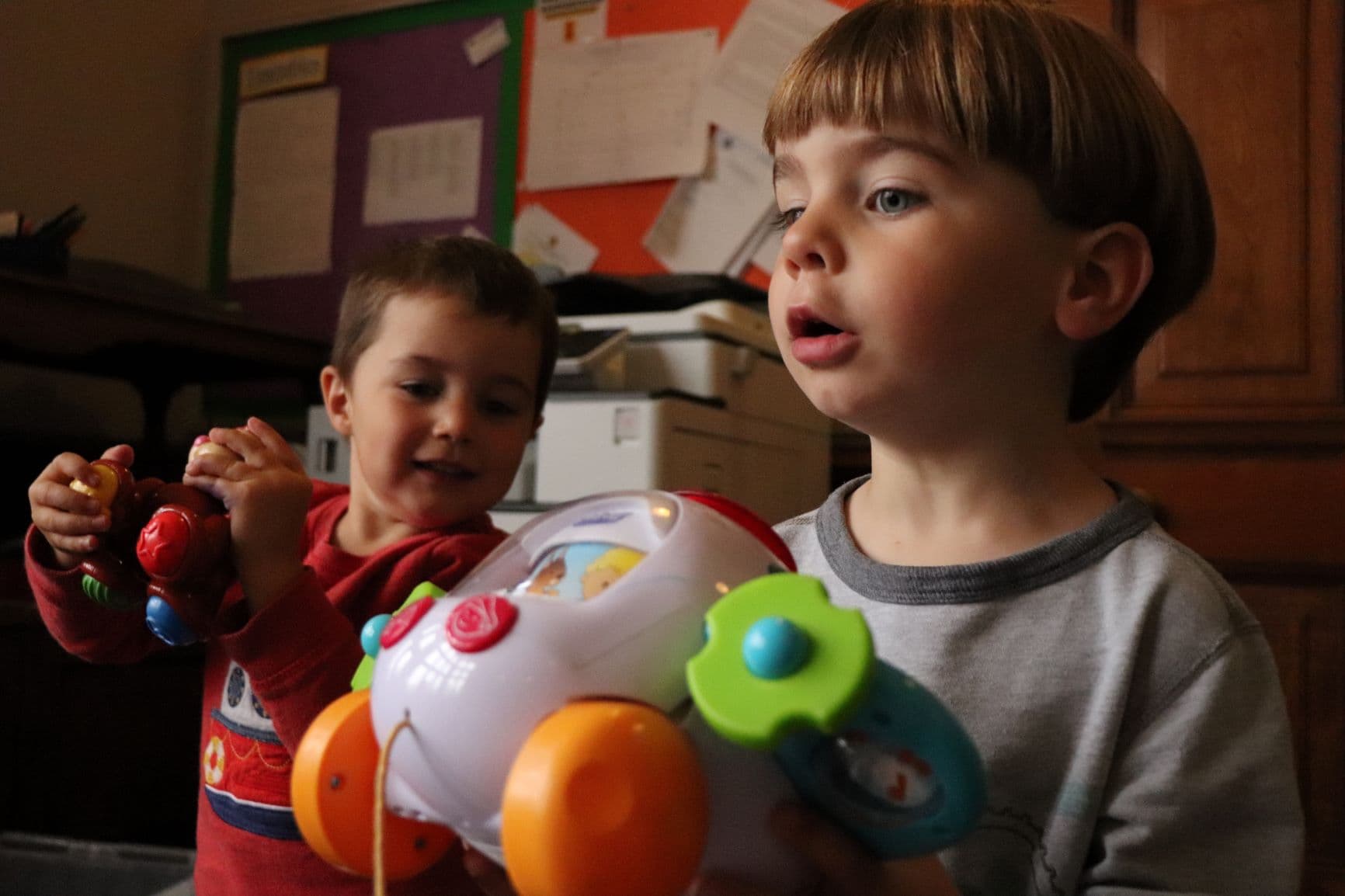 two young children playing with toys