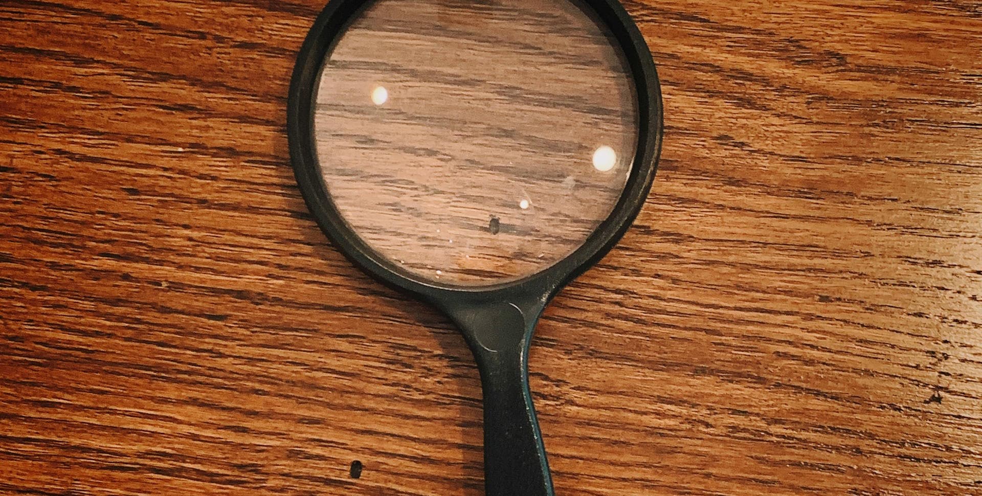 magnifying glass over a wooden table