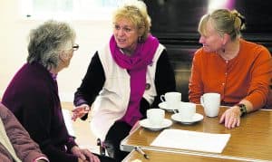 three ladies talking over coffee